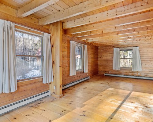 An interior of an empty room in a wooden house