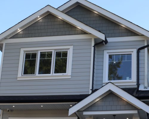 A low-angle view of modern houses in the background of sky