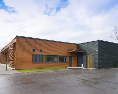 A modern building, a pre-school entrance and playground